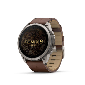 Garmin Fenix 9 Pro älykello etuviistosta harmaalla titaanikuorella ja pähkinänruskealla nahkarannekkeella