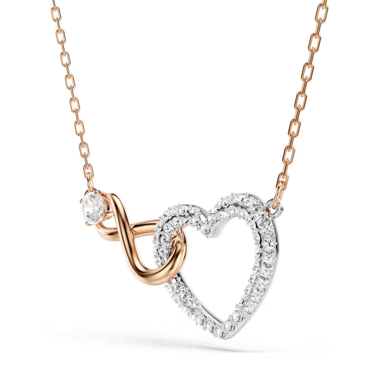 Swarovski kaksivärinen infinityriipus kirkkailla kristalleilla ja rosekullan sävyisellä ketjulla, sydämenmuotoinen riipusosa pudottavassa asennossa